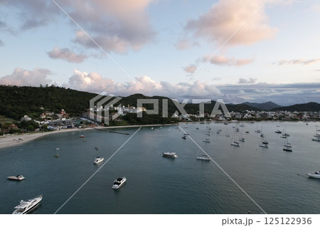 Peaceful evening at the marina with boats anchored in calm waters 125122936
