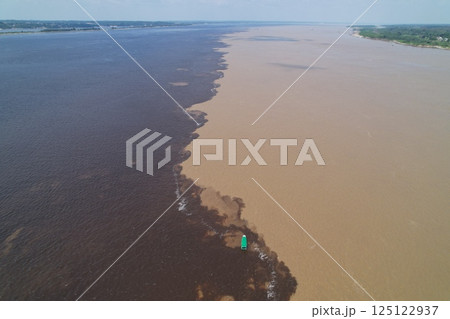 Convergence of Rio Negro and Amazon River showcasing distinct water colors 125122937