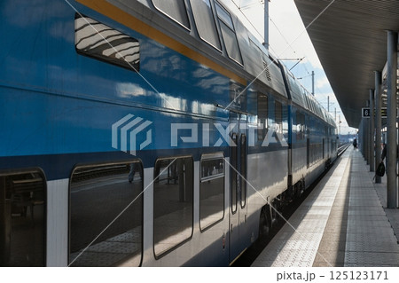 Double-decker passenger train at a station platform 125123171