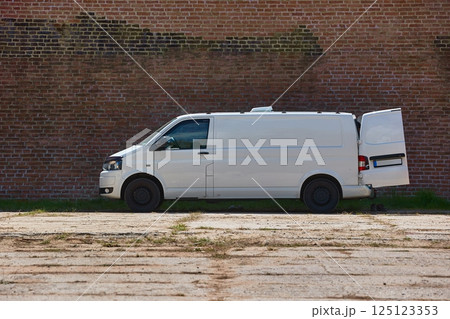 White van in front of a brick wall White van in front of a brick wall 125123353