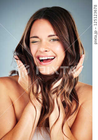 Hair care, comic and face of a woman for a salon, wellness and luxury treatment against a blue studio background. Beauty, crazy and portrait of a happy model with cosmetics care for growth of hair Hair care, comic and face of a woman for a salon, wellness and luxury treatment against a blue studio background. Beauty, crazy and portrait of a happy model with cosmetics care for growth of hair 125123678