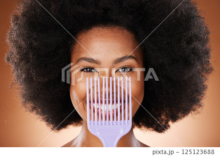 Hair care, comb and black woman with smile, natural beauty and skincare against brown studio background. Cosmetics, beautician and African American woman with afro, combing and happy with portrait. Hair care, comb and black woman with smile, natural beauty and skincare against brown studio background. Cosmetics, beautician and African American woman with afro, combing and happy with portrait. 125123688