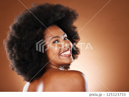 Beauty, skincare and a happy black woman with a smile and afro looking back on studio background. Health, wellness and youth, a woman with body care, healthy glowing skin and happy grooming lifestyle 125123733