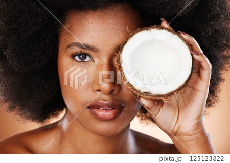 Beauty, skincare and black woman with coconut for a cosmetic healthcare product, healthy skin treatment and natural wellness. Organic health portrait, clean diet and self care nutrition studio mockup 125123822