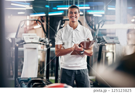 Gym, fitness and portrait of a personal trainer with a clipboard for a training consultation. Happy, smile and sports coach or athlete with a wellness, health and exercise checklist in workout center Gym, fitness and portrait of a personal trainer with a clipboard for a training consultation. Happy, smile and sports coach or athlete with a wellness, health and exercise checklist in workout center 125123825