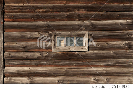 Old log wall with small window Old log wall with small window 125123980