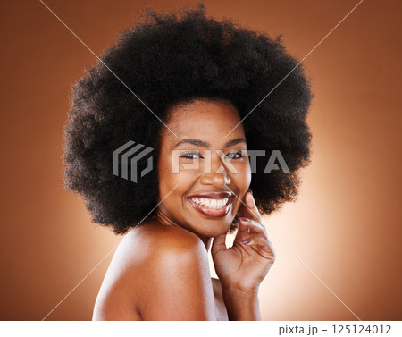 Black woman afro, teeth and smile for skincare, cosmetics or makeup against a studio background. Portrait of happy African American female model smiling for body care or cosmetic facial treatment 125124012