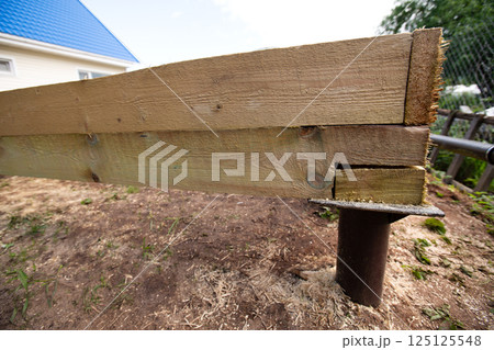 Wooden frame house foundation on screw piles Wooden frame house foundation on screw piles 125125548