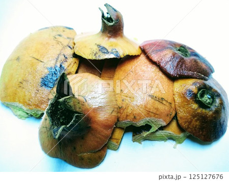 A picture of pomegranate rinds isolated on a white background A picture of pomegranate rinds isolated on a white background 125127676