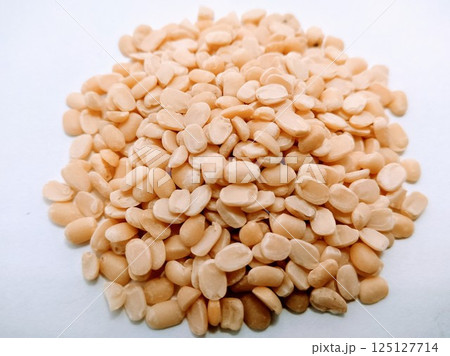 A picture of split black lentil without rind isolated on white background A picture of split black lentil without rind isolated on white background 125127714