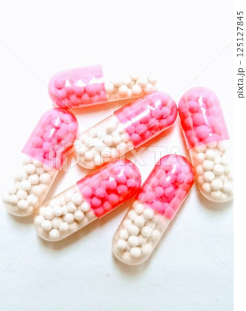 A picture of red and white capsules isolated on white background A picture of red and white capsules isolated on white background 125127845