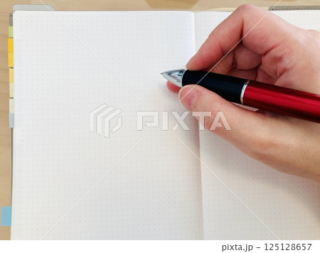 ノート・手帳に書き込む 125128657