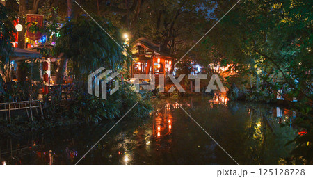 Chengdu, Sichuan, China. Pond Illuminated With Asian Lanterns. Silence And Peace. Traditional Red Chinese Lanterns. Paper Lantern Is Symbol Of Hearth, Comfort, Kindness. Night Illumination. In Asian Chengdu, Sichuan, China. Pond Illuminated With Asian Lanterns. Silence And Peace. Traditional Red Chinese Lanterns. Paper Lantern Is Symbol Of Hearth, Comfort, Kindness. Night Illumination. In Asian 125128728