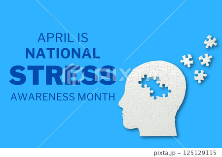 Stress month, head made of white puzzles on a blue background with text, top view 125129115