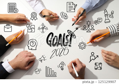 Goals 2025, hands of colleagues on a light office table, planning. 125129907