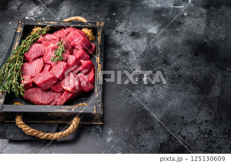 Diced Roe Deer meat, raw Venison Wild Game Meat. black background. top view Diced Roe Deer meat, raw Venison Wild Game Meat. black background. top view 125130609