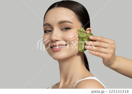 Botox. Skin Care. The girl is getting a face massage, using the gouache method. Botox. Skin Care. The girl is getting a face massage, using the gouache method. 125131318