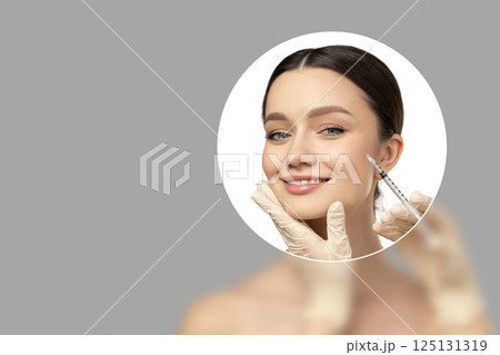 Botox. Skin Care. A girl gets a botox injection, on a light background. 125131319