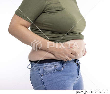 Close up of overweight young woman with fat belly 125132570