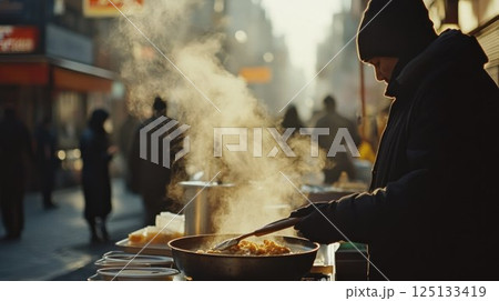 Street vendor cooking food outdoors on a cold day. 125133419
