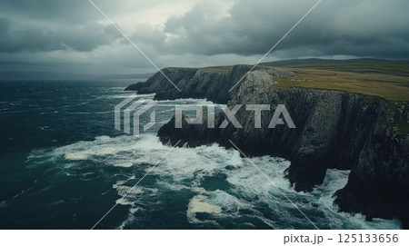 Dramatic coastal cliffs under a cloudy sky. 125133656