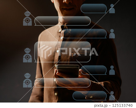 Asian man uses mobile phone to interact with AI conversation Asian man uses mobile phone to interact with AI conversation 125133740