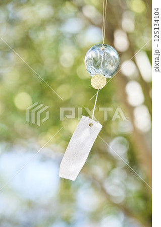 夏の木漏れ日の下で風に揺れる風鈴 夏の木漏れ日の下で風に揺れる風鈴 125134104