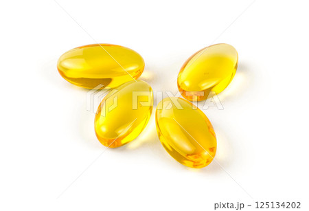 Golden oval soft gel capsules on white surface, omega 3 fish oil supplement for daily nutrition, energy, beauty, and health care Golden oval soft gel capsules on white surface, omega 3 fish oil supplement for daily nutrition, energy, beauty, and health care 125134202