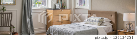Modern cozy bedroom interior with sunlight soft neutral tones wooden furniture bed pillows curtain lamp morning home inspiration 125134251