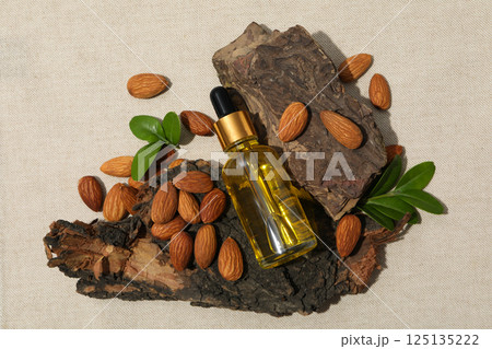 Almonds oil, concept of different cosmetic and skin care accessories 125135222