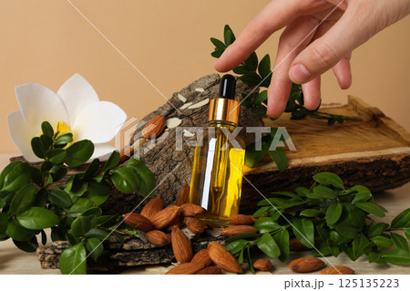 Almonds oil, concept of different cosmetic and skin care accessories 125135223
