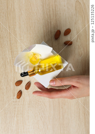 Almonds oil, concept of different cosmetic and skin care accessories 125135226
