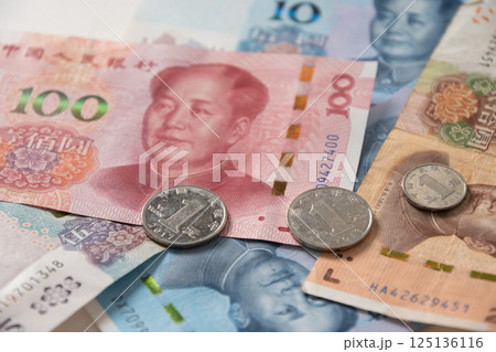 Many of different Chinese yuan banknotes. Chinese paper currency Yuan renminbi banknotes and coins as background. 125136116