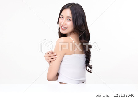 Beauty portrait of happy Asian female face with natural skin make up isolated on white background. Beauty portrait of happy Asian female face with natural skin make up isolated on white background. 125138040