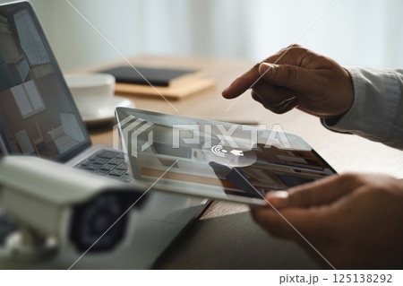 cctv security system man monitoring at office from smart phone Camera Footage On Screen 125138292