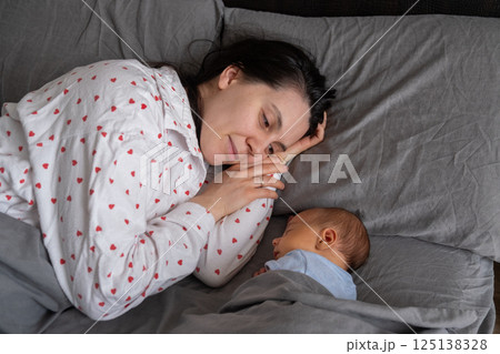 Mother and Baby Sleeping Peacefully Together Mother and Baby Sleeping Peacefully Together 125138328