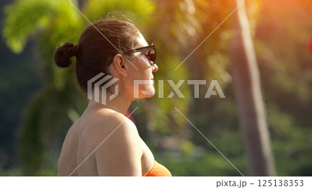 Tourist woman enjoying tropical vacation Tourist woman enjoying tropical vacation 125138353