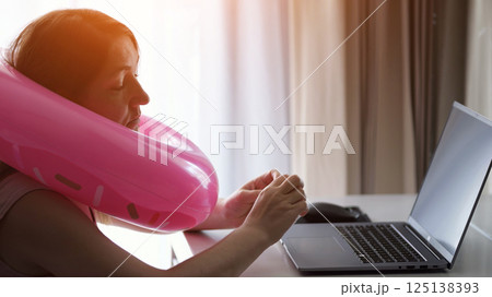 Woman dreaming of vacation while working from hotel room Woman dreaming of vacation while working from hotel room 125138393