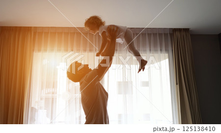 Happy father tosses little girl up and child laughs joyfully Happy father tosses little girl up and child laughs joyfully 125138410