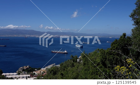 Cargo Ships Sailing on the Bay of Gibraltar on a Sunny Day 125139545