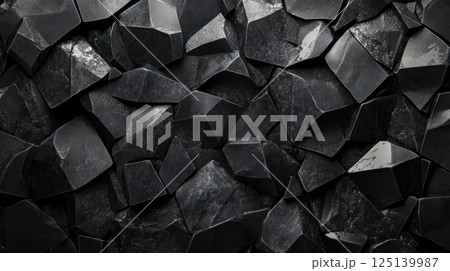 A textured close-up of dark, jagged stone surfaces 125139987