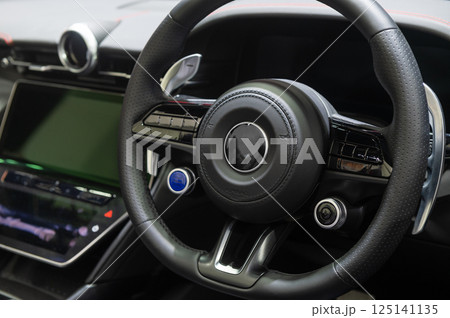 Leather steering wheel of car with luxurious details 125141135
