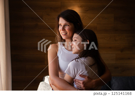 Generational love. Mom and daughter hugging each other. Family traditions passed through embrace. Heritage, parenting, childhood concept. 125141168