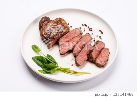 A perfectly cooked sliced striploin steak with a juicy, tender texture 125141469