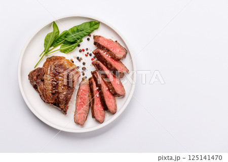 A perfectly cooked sliced striploin steak with a juicy, tender texture 125141470