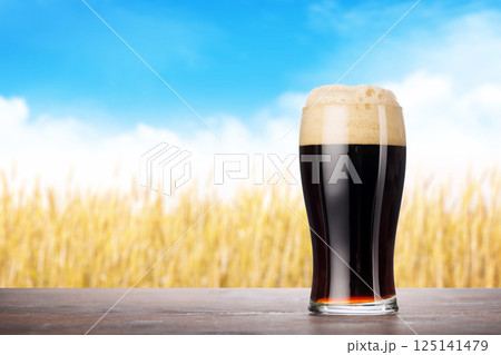 A glass of stout beer with a frothy head A glass of stout beer with a frothy head 125141479