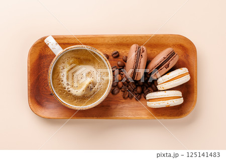 Top view of a coffee cup and macaroons Top view of a coffee cup and macaroons 125141483