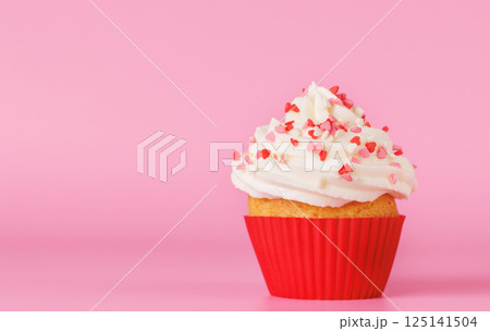 Festive cupcake topped with swirled frosting Festive cupcake topped with swirled frosting 125141504