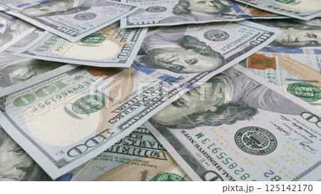 A CloseUp View of Various Different U.S. Dollar Bills Beautifully Laid Out on a Table Surface 125142170
