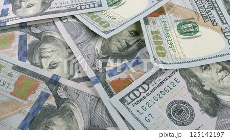 A visually striking display of Stacked Hundred Dollar Bills resting on a flat Surface 125142197
